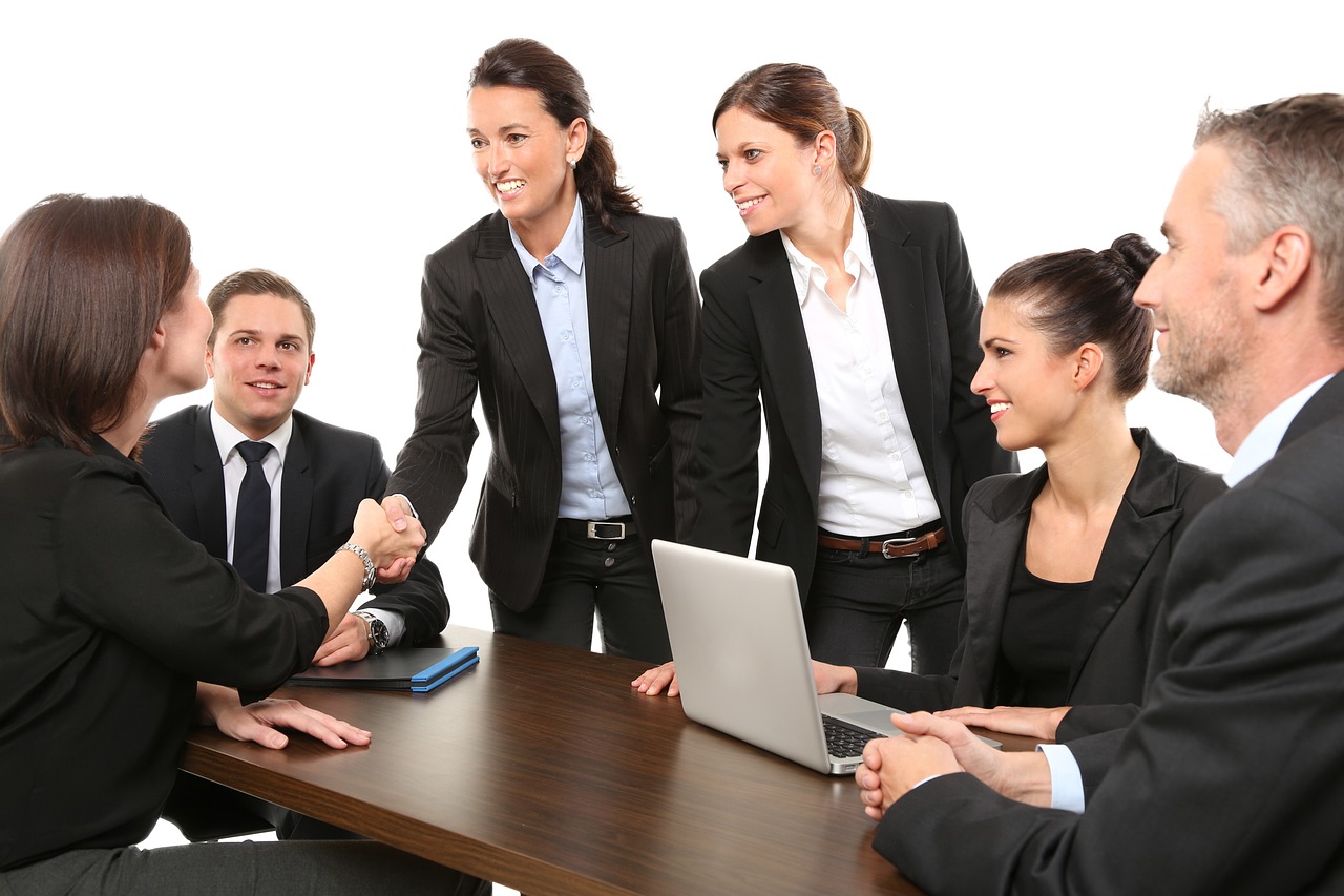 a group of business people sitting around a table, a picture, shutterstock, shaking hands, wearing causal black suits, centred, praised