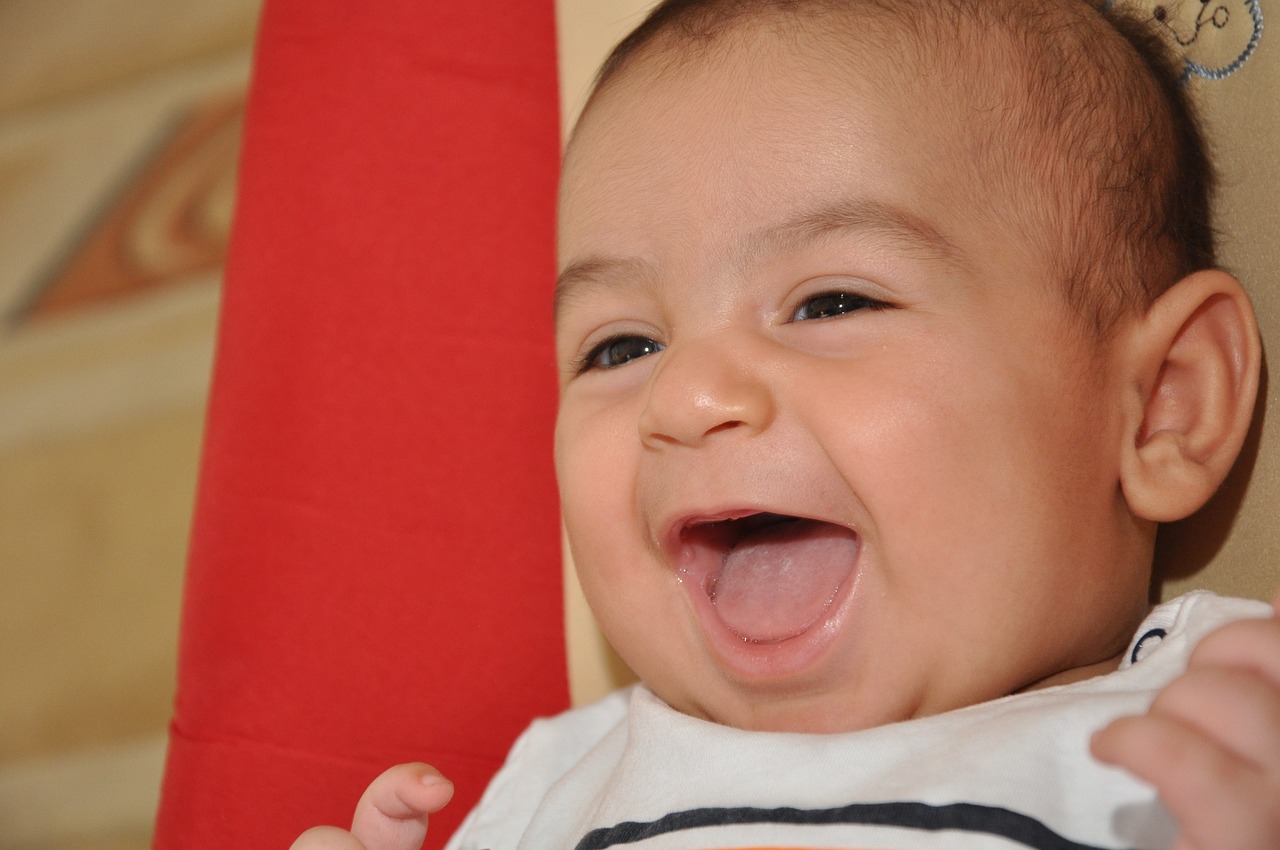 a close up of a baby with an open mouth, dada, mutahar laughing, triumphant pose, red cheeks, caio santos