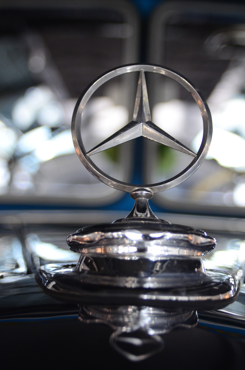 a close up of a mercedes emblem on a car, a hologram, by Thomas Häfner, pexels, on a pedestal, looking towards camera, view from below, 188216907