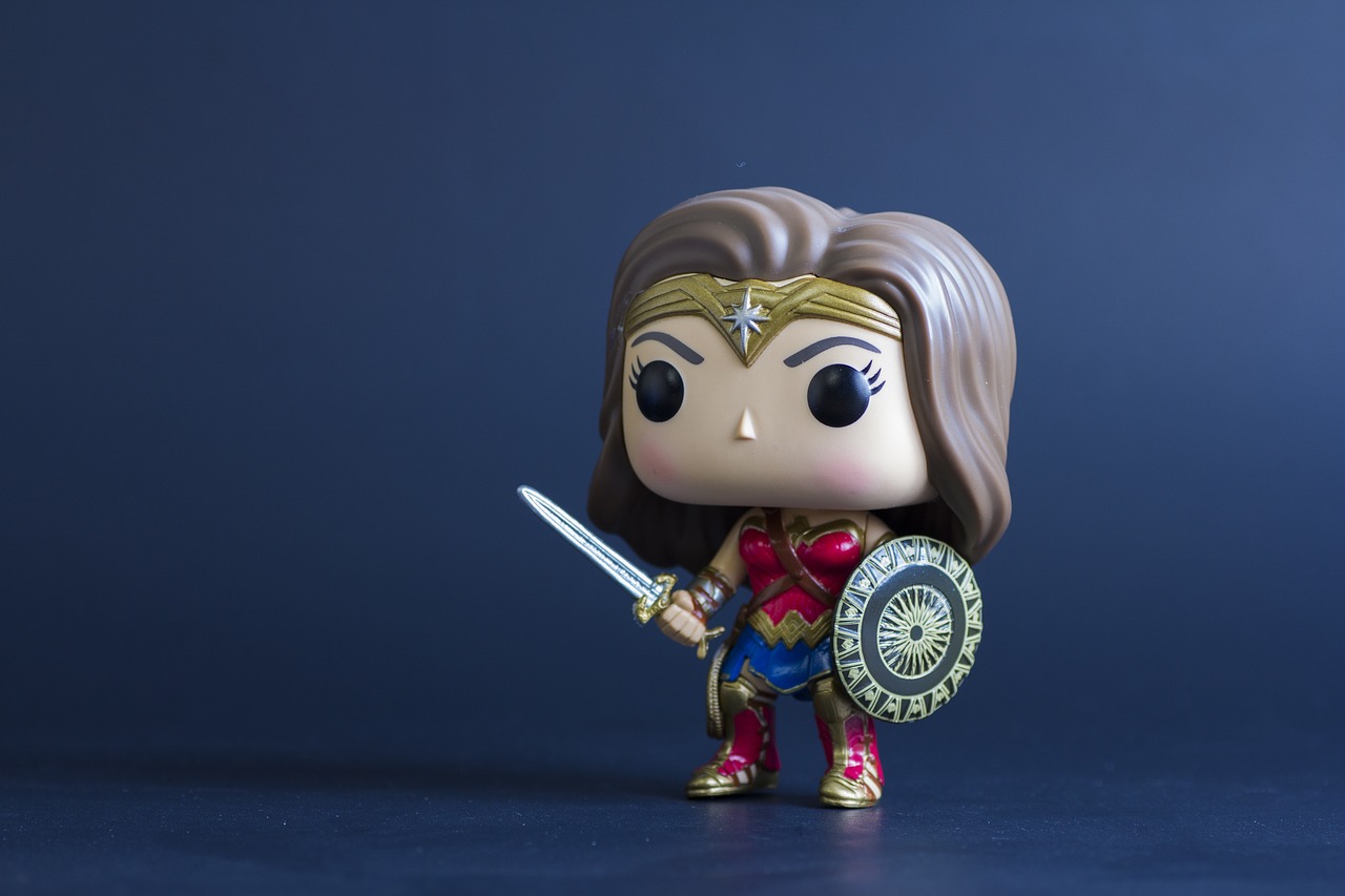 a close up of a figurine of a woman with a sword and shield, inspired by Zack Snyder, pop art, mascot pop funko, half body photo