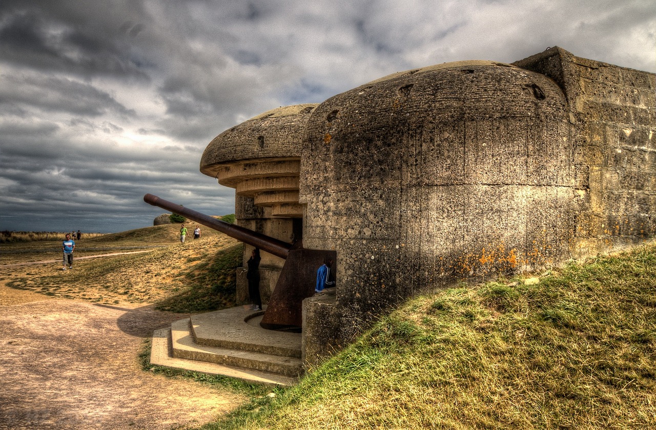 a cannon sitting on top of a cement structure, a photo, by Etienne Delessert, flickr, cyberdemon on omaha beach, intense dramatic hdr, door gunner, on dune