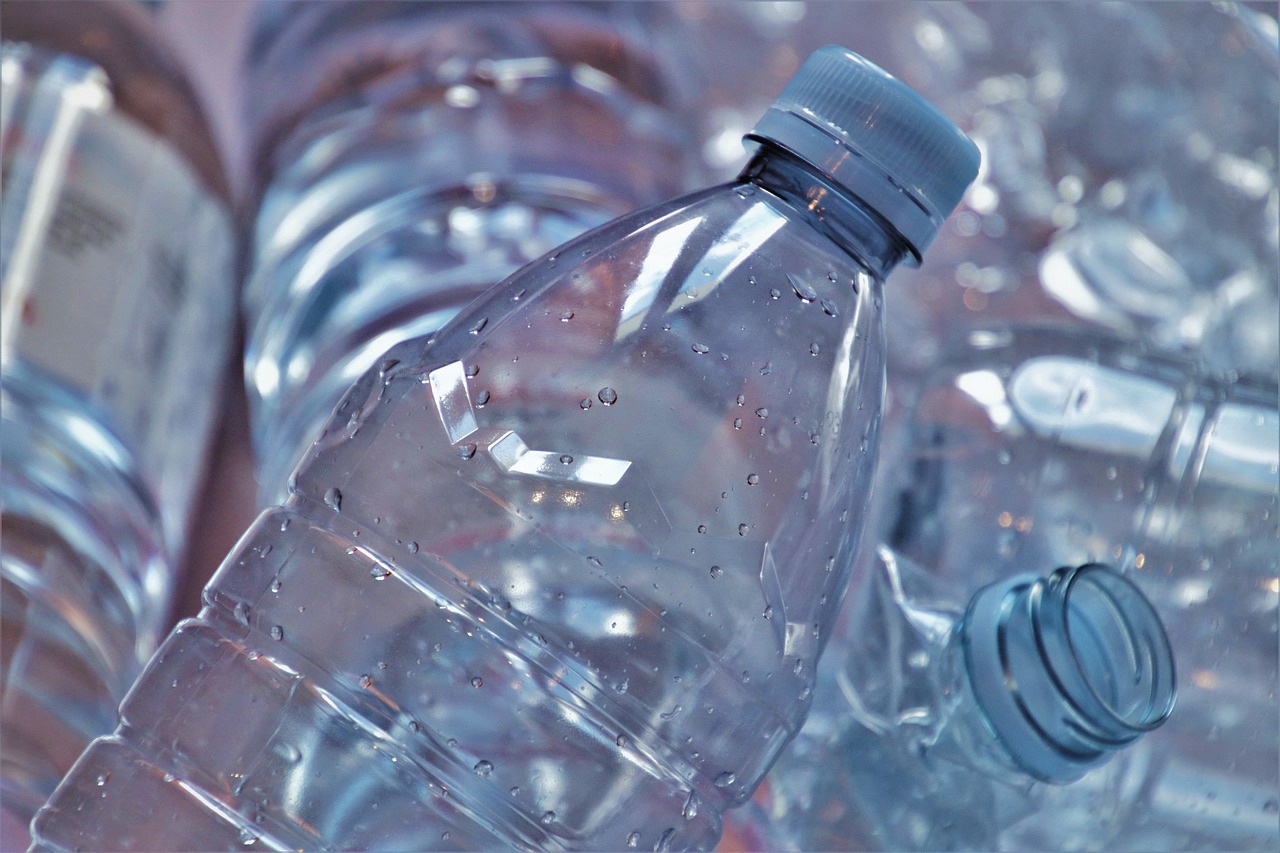 a group of water bottles sitting next to each other, plasticien, subtle detailing, close up details, overflowing, image