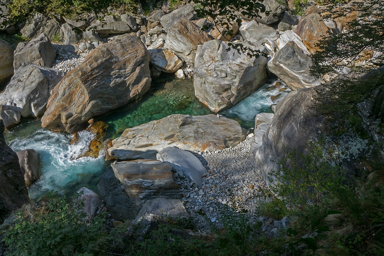 a river flowing through a lush green forest filled with rocks, by Robert Griffier, flickr, beach is between the two valleys, marble!! (eos 5ds r, flowing teal-colored silk, intense colours