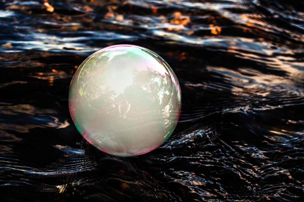 a white sphere floating on top of a body of water, a picture, unsplash, digital art, bubble gum, bubbling cauldron, profile picture, iridescent