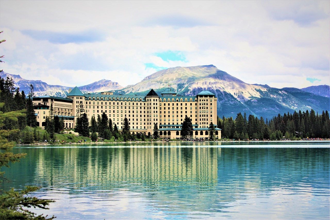 a large building sitting on top of a lake, a photo, by Richard Carline, shutterstock, whistler, hotel, new mexico, iphone photo