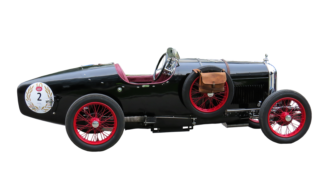 a black car with red rims on a black background, art nouveau, racecar, manufactured in the 1920s, motorsports photography, bentley