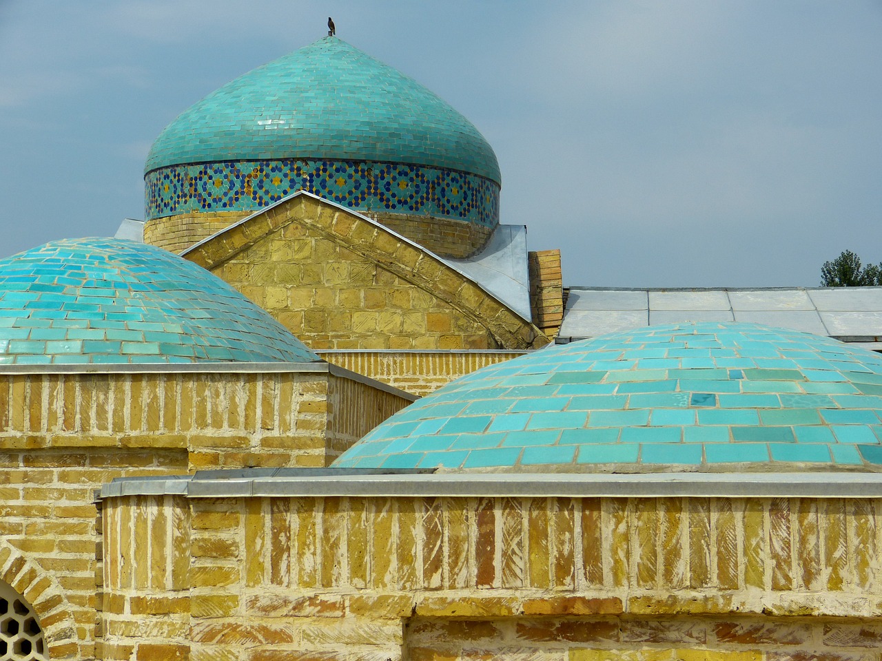 a large building with a blue dome on top of it, a mosaic, inspired by Kamāl ud-Dīn Behzād, trending on pixabay, arabesque, gold and teal color scheme, stone roof, sayem reza, roofs