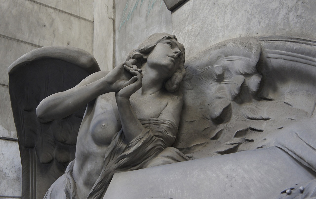 a statue of an angel on the side of a building, inspired by Jules Joseph Lefebvre, flickr, art nouveau, inside a tomb, odeith, sparse detail, female death
