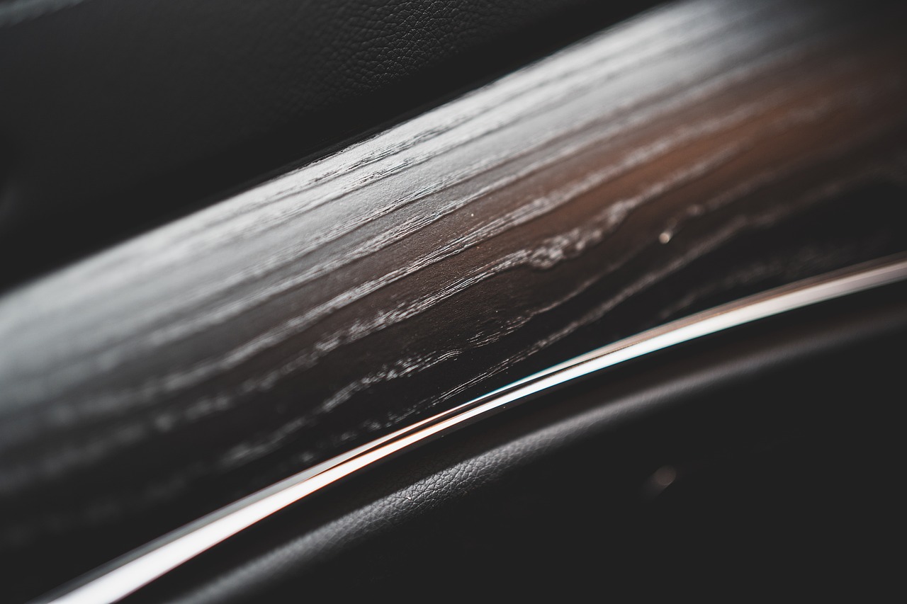 a close up of the seat of a car, a macro photograph, purism, polished with visible wood grain, dark-toned product photos, streaks, vinyl