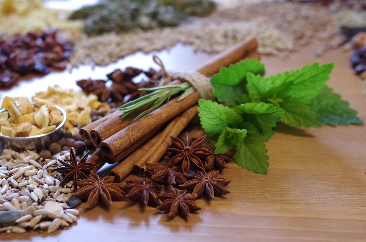 a bunch of spices sitting on top of a wooden table, by Anna Haifisch, renaissance, mint leaves, cinnamon, ❤🔥🍄🌪, orthodox