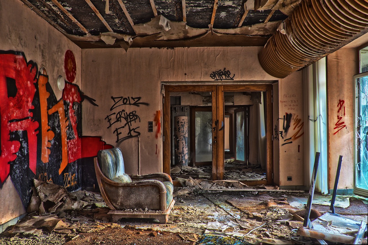 a chair in a run down room with graffiti on the walls, huge smashed mansion, 3 4 5 3 1