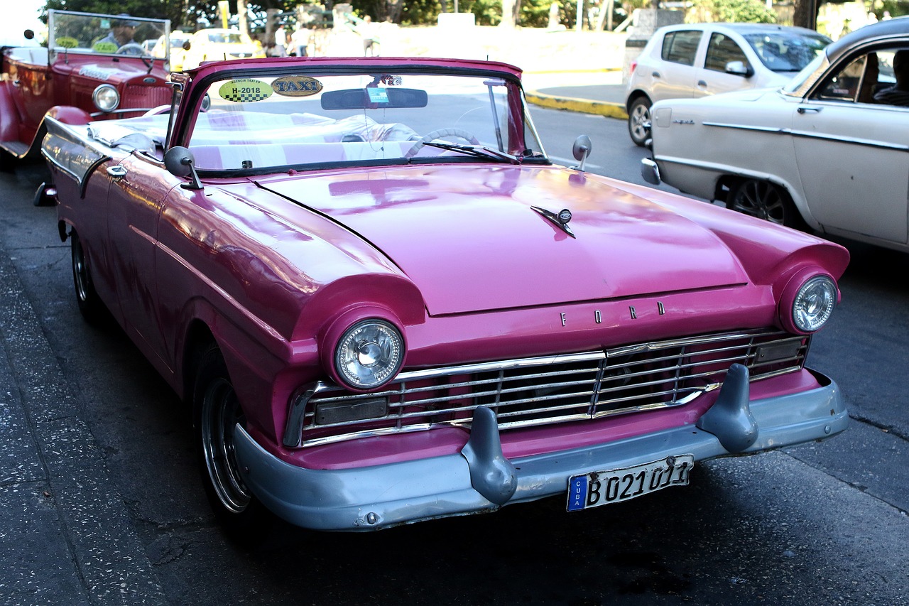 a pink car is parked on the side of the road, by Sven Erixson, flickr, looking regal and classic, doruk erdem, twirls, mercury