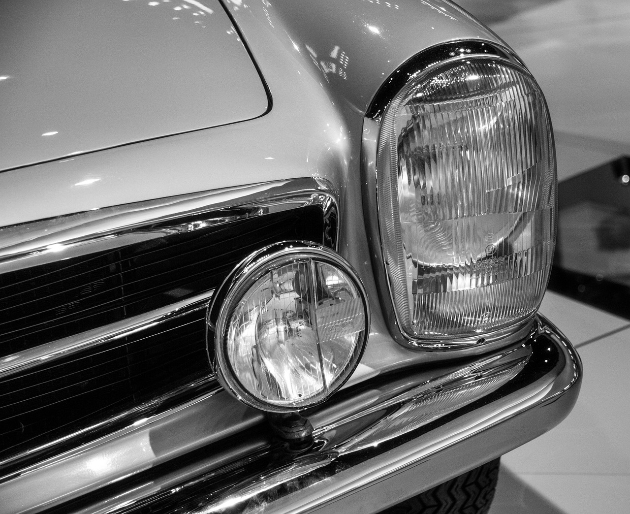 a black and white photo of a classic car, a black and white photo, trending on pixabay, headlights, mercedez benz, on display, 2 4 mm iso 8 0 0 color