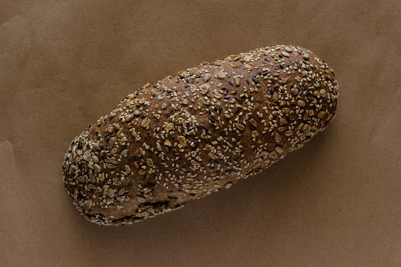 a loaf of bread sitting on top of a table, a stipple, flickr, sōsaku hanga, fred tomaselli, fuji pro 400h, panorama, ffffound