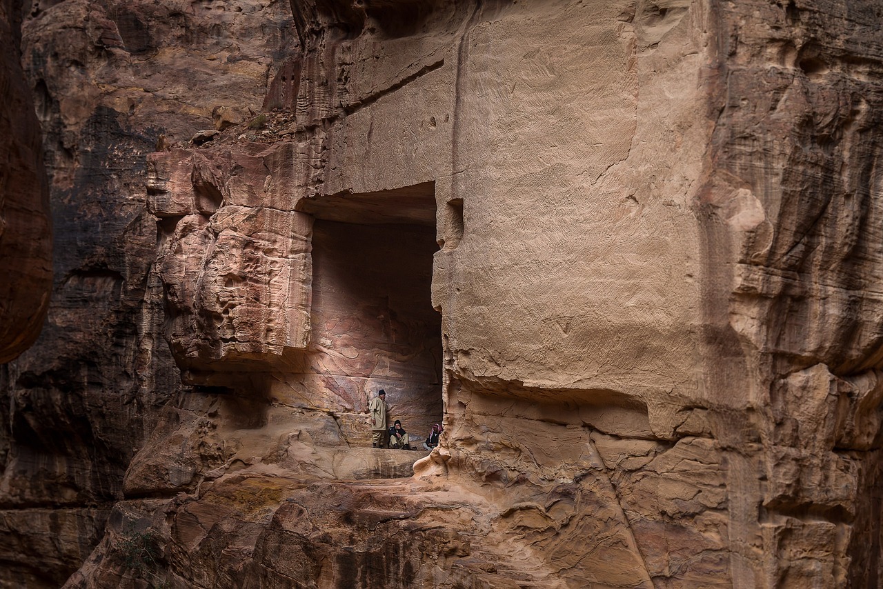 a couple of people that are standing in a cave, by Richard Carline, hoffman bicycle trip, high detail photo of a deserted, sandstone, afternoon hangout
