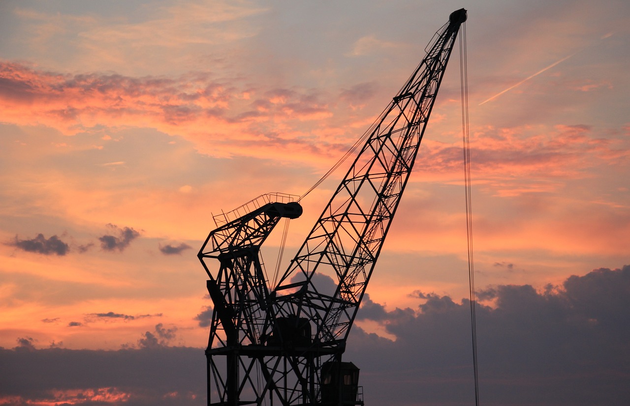 a crane is silhouetted against a sunset sky, constructivism, watch photo