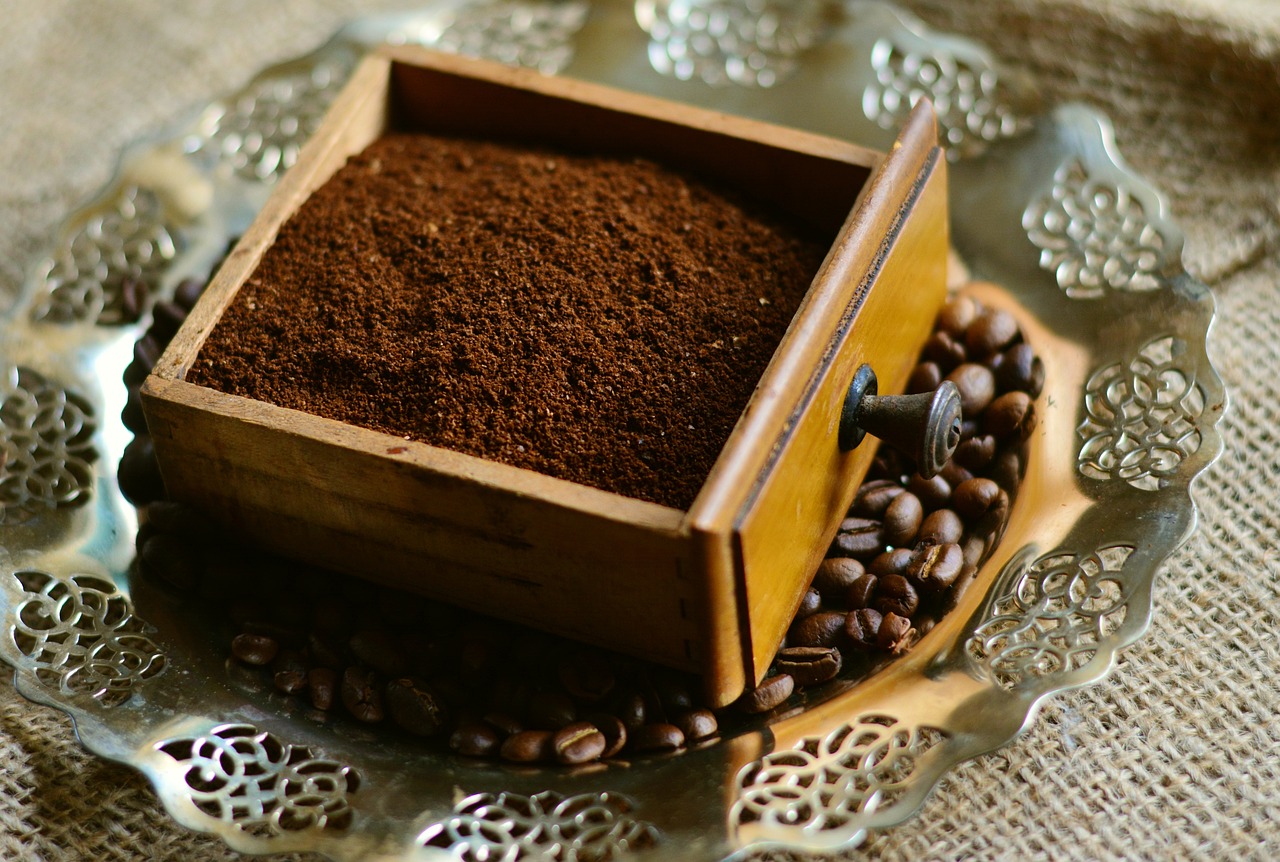 a small wooden box filled with coffee beans, by Kurt Roesch, shutterstock, hurufiyya, sand particles, on a wooden tray, arabica style, powder