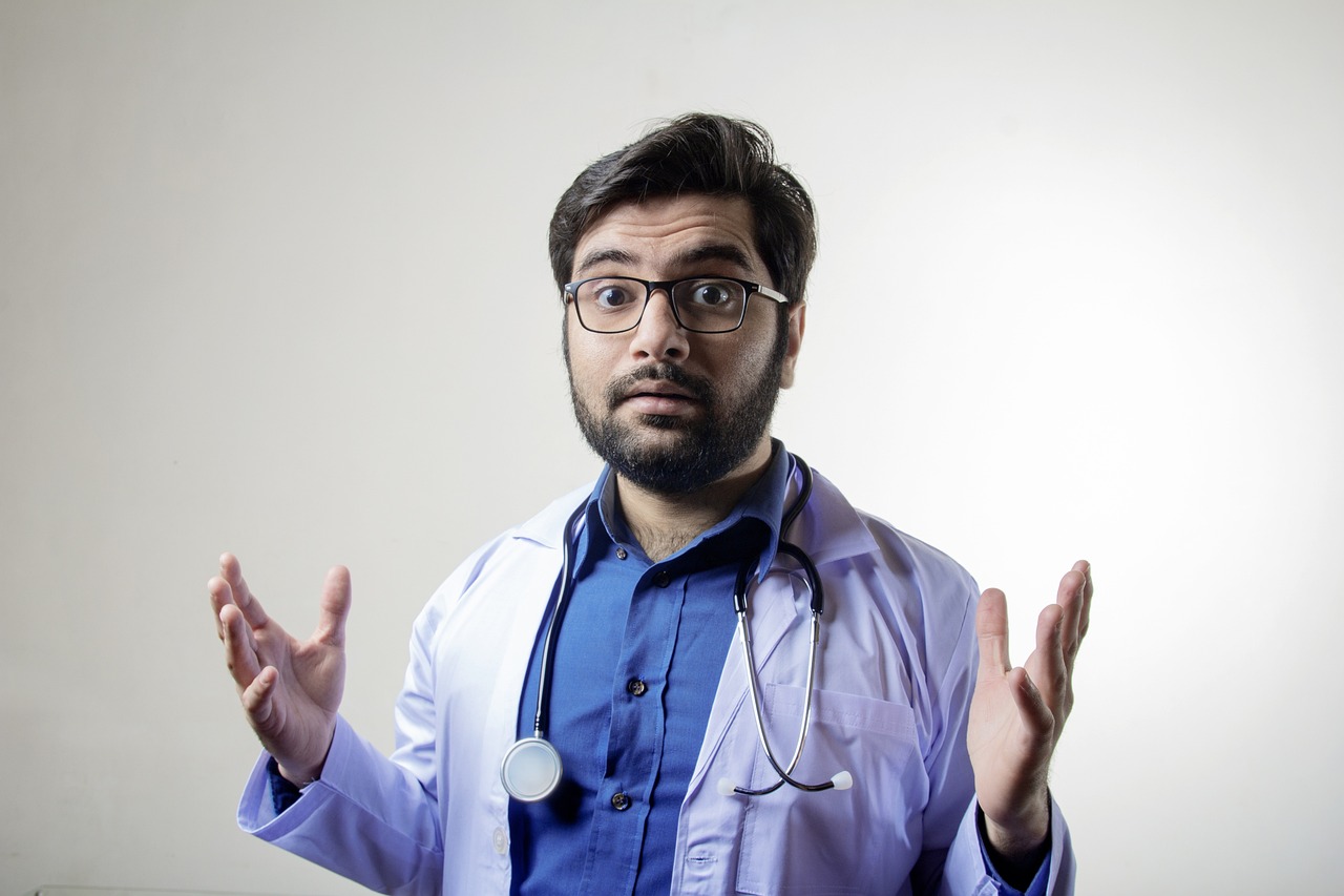 a man in a lab coat with a stethoscope, a stock photo, confused facial expression, jewish young man with glasses, wearing blue robe, very attractive man with beard