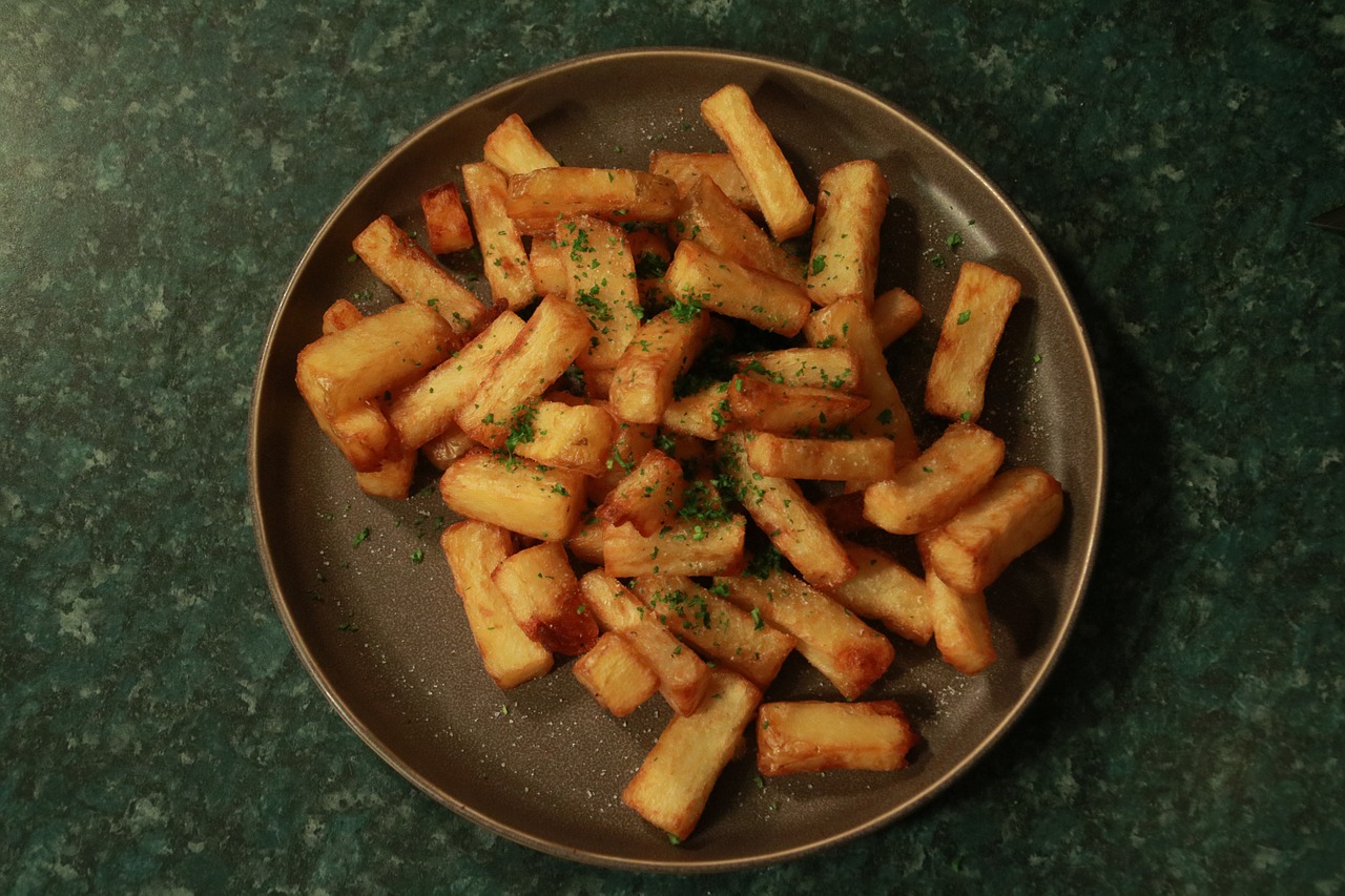 a close up of a plate of food on a table, inspired by Pia Fries, frying nails, on black background, in john salt style, homemade