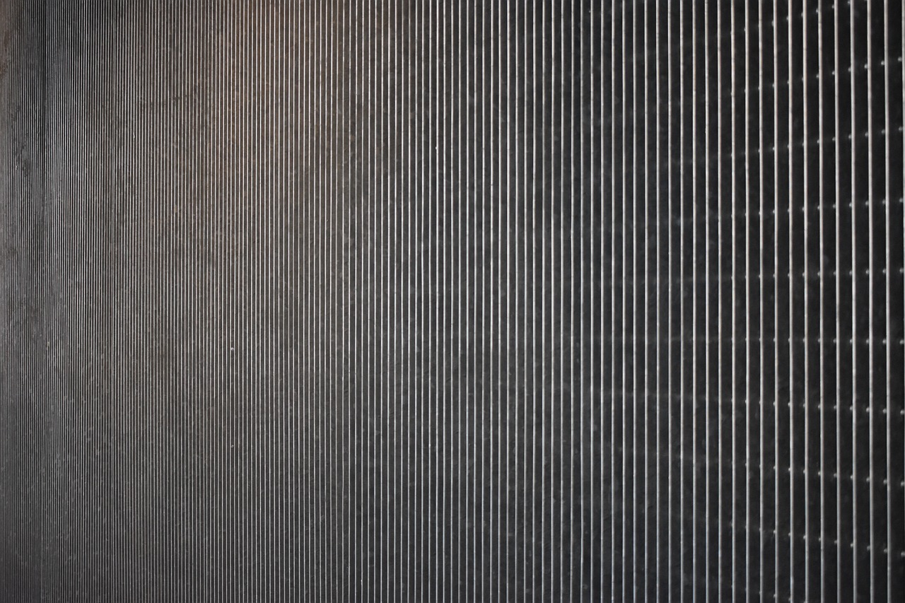 a red fire hydrant sitting on the side of a building, inspired by Andreas Gursky, postminimalism, paper texture 1 9 5 6, black vertical slatted timber, radiator, anthracite