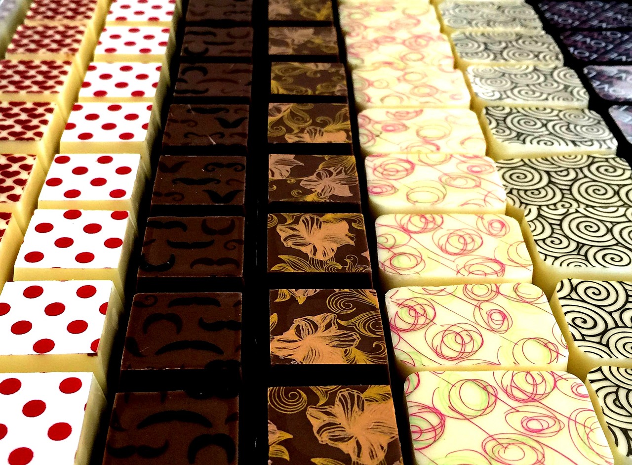 a table topped with lots of different types of chocolate, op art, in a row, unwind!, upclose, damask patern