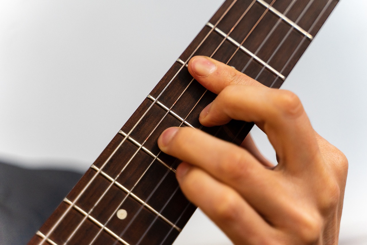 a close up of a person playing a guitar, by Ottó Baditz, only five fingers, vertical lines, webbing, kazuma kaneko