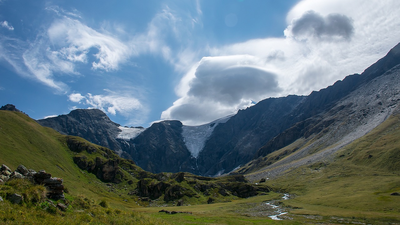 a view of a valley with mountains in the background, by Werner Andermatt, flickr, les nabis, giant cumulonimbus cloud, glacier, view from ground, gorge in the mountain