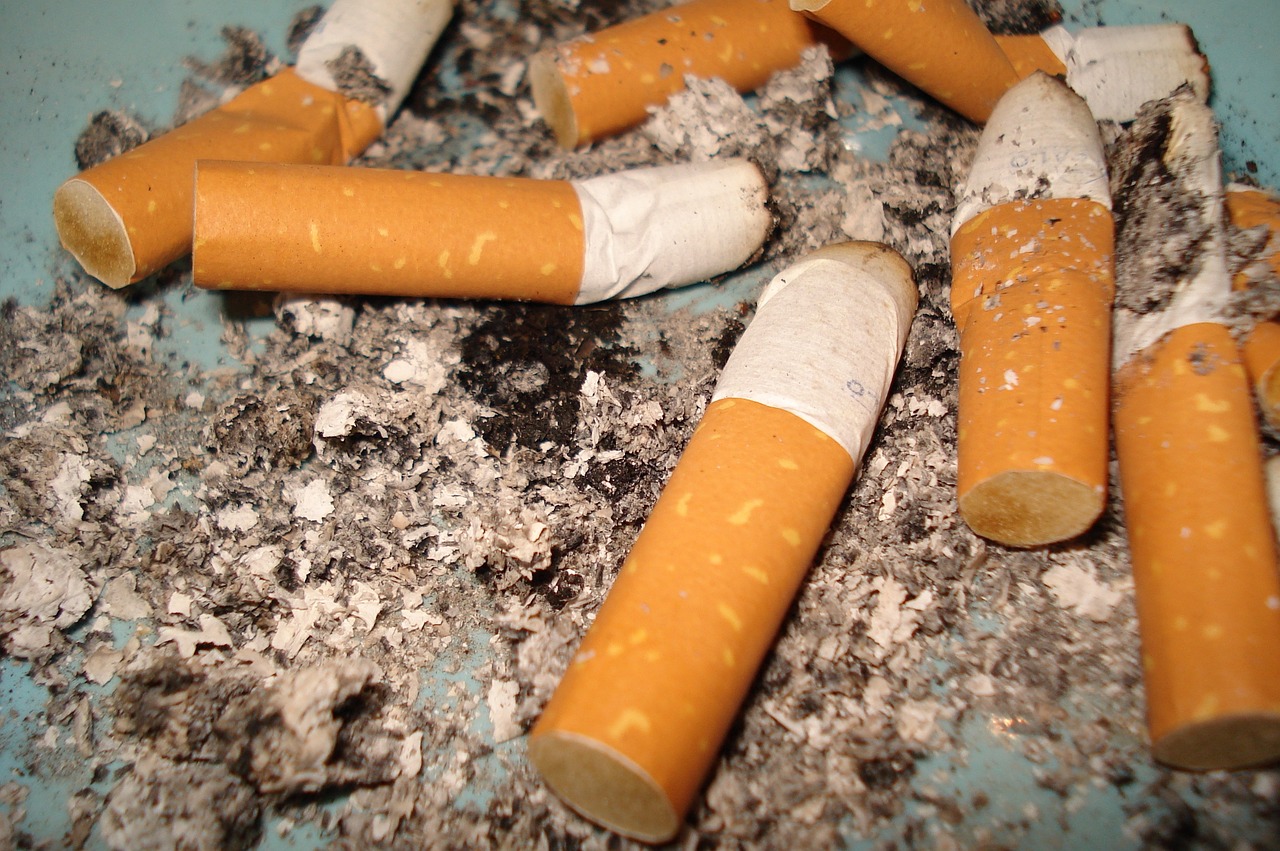a pile of cigarettes sitting on top of a blue plate, a picture, inspired by William Harnett, shutterstock, happening, damaged floor, closeup photo, stubbles, 2 0 1 0 photo