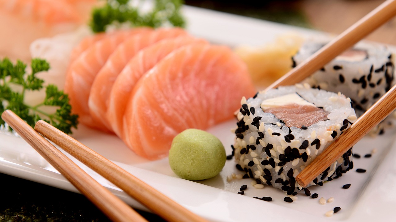 a white plate topped with sushi and chopsticks, a picture, inspired by Nishida Shun'ei, salmon, istock, shiny and sparkling, avatar image