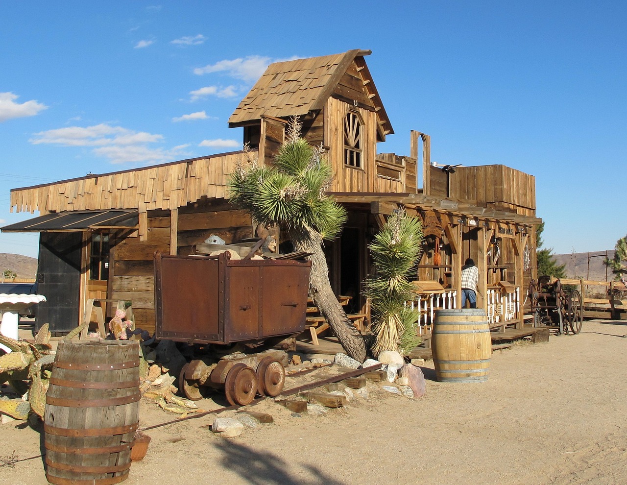 a wooden building sitting in the middle of a desert, by Linda Sutton, flickr, renaissance, a steampunk store, mule, replica model, log houses built on hills
