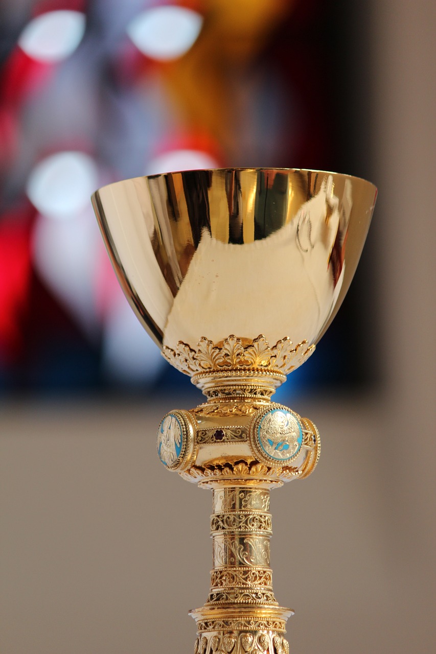 a golden cup sitting on top of a table, a picture, roman catholic icon, taken with canon 8 0 d, choir, unedited