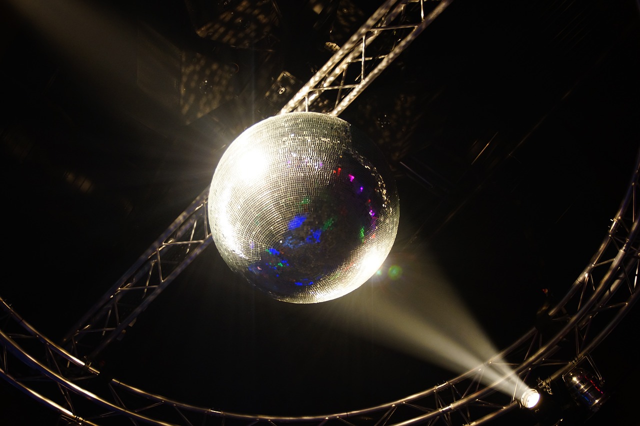 a disco ball is lit up in the dark, by Robin Guthrie, flickr, spotlights from ceiling, antichrist dancing at studio 54, blog-photo, very sad