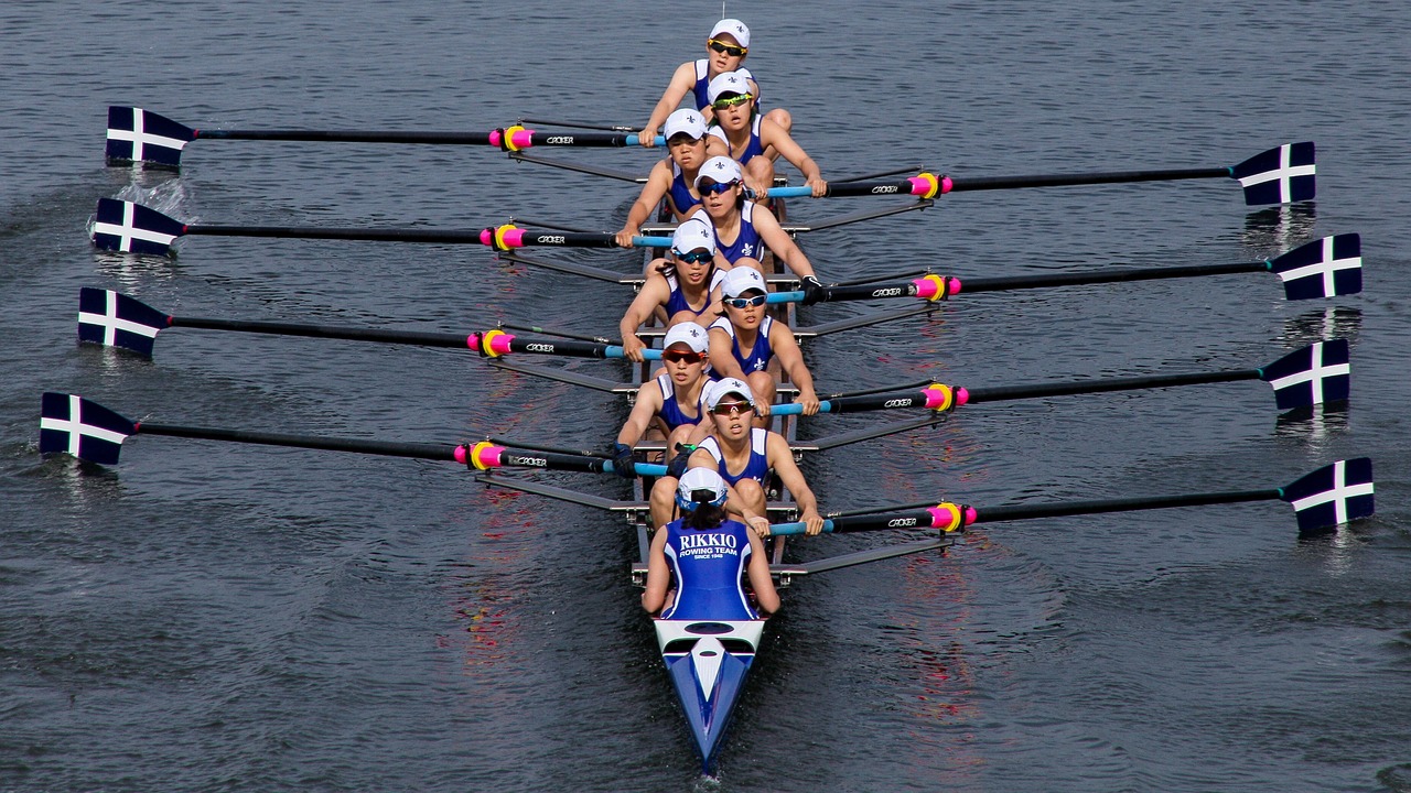 a group of women rowing across a body of water, a portrait, flickr, ultramarine, olympics, imgur, 4 0 9 6