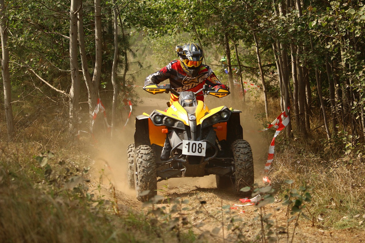 a man riding on the back of a yellow atv, a picture, by Dietmar Damerau, shutterstock, motorsports photography, amongst foliage, performance, tournament