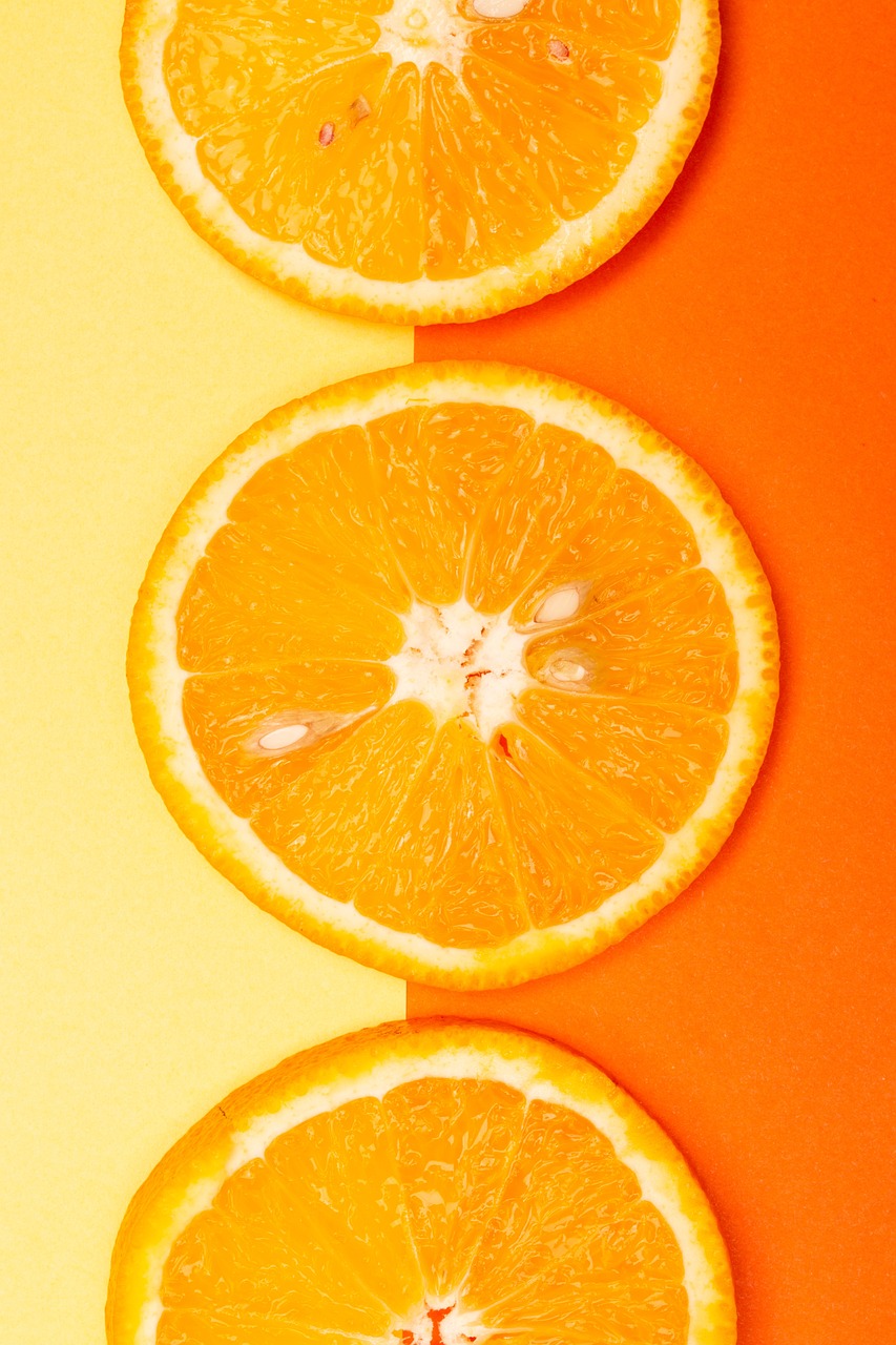 three slices of orange sitting on top of each other, by Anna Haifisch, trending on unsplash, postminimalism, 🦩🪐🐞👩🏻🦳, yellow aureole, vivid colors!, unlimited juice