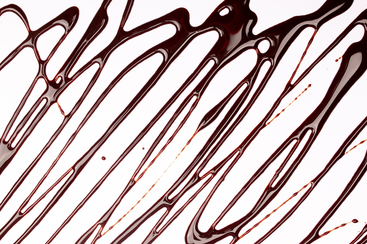 a group of spoons sitting on top of a table, a microscopic photo, inspired by Lucio Fontana, abstract illusionism, chocolate sauce, close-up product photo, lines, highly detailed product photo