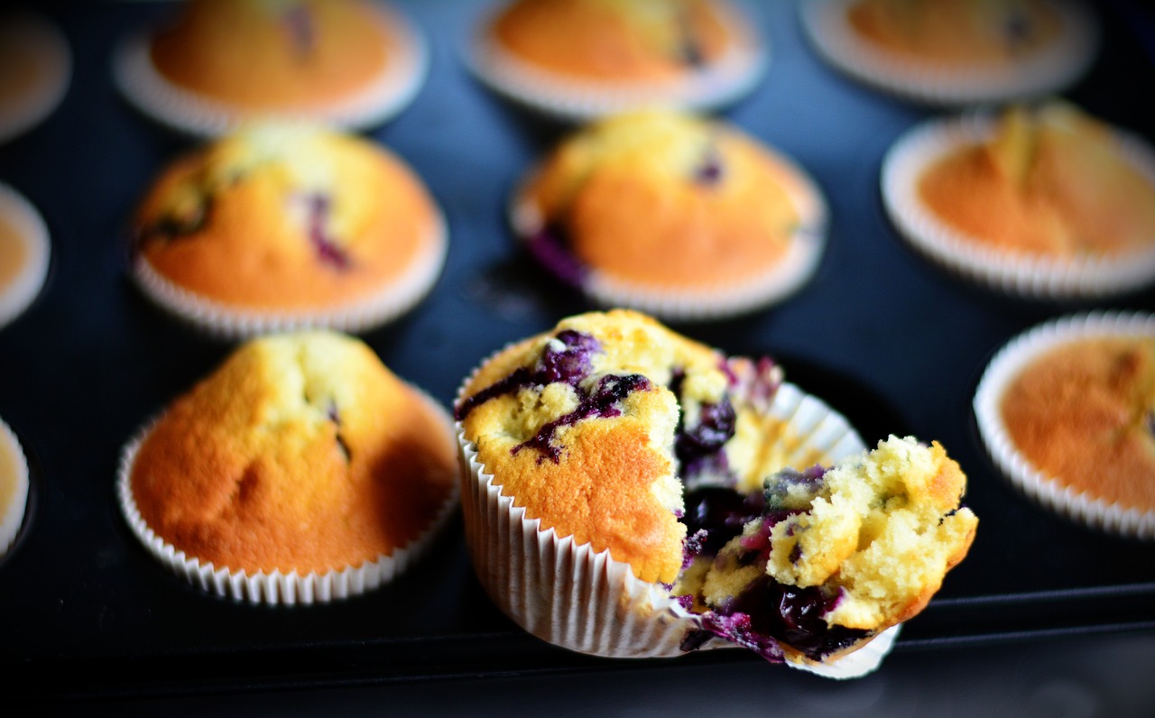 a muffin with a bite taken out of it, a picture, by Yi Jaegwan, pexels, hurufiyya, blueberries, rectangular, open, overload