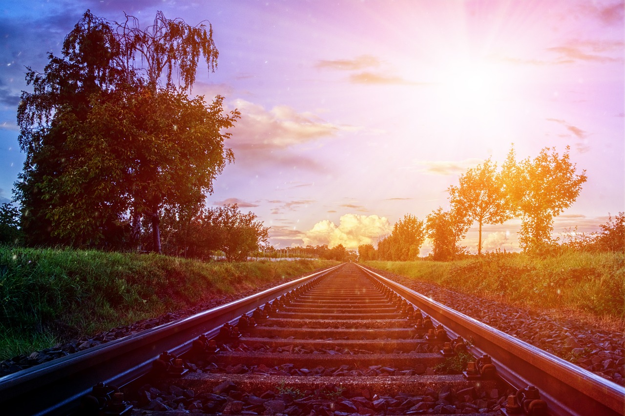 a train track with a sunset in the background, shutterstock, realism, photorealistic - h 6 4 0, sunny mid day, edited, springtime morning