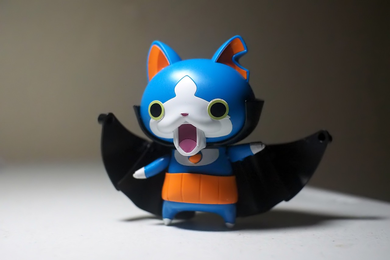 a close up of a figurine of a cat, a picture, by Hiroyuki Tajima, flickr, an anime nendoroid of son goku, banshee, angry batman, blue!! with orange details