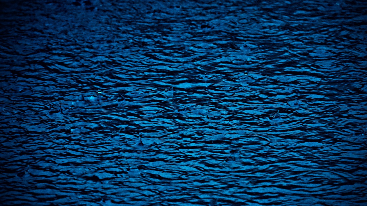 a close up of the surface of a body of water, by Hans Schwarz, pexels, midnight blue, hard morning light, lsd ripples, high quality photo