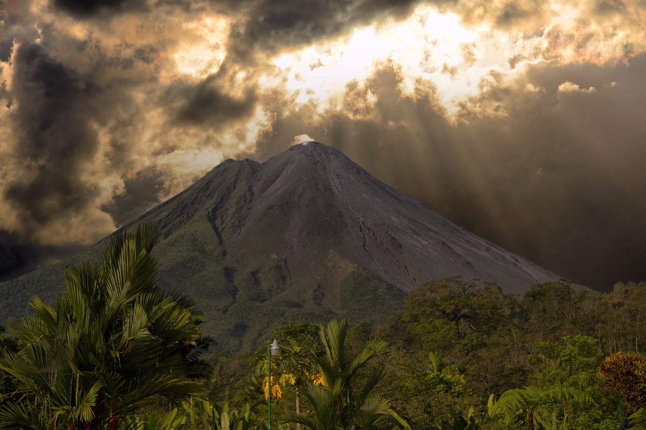 the sun shines through the clouds over a mountain, a portrait, inspired by Frederic Edwin Church, shutterstock, sumatraism, the earth sprouts lava, silver, colombian jungle, ancient”