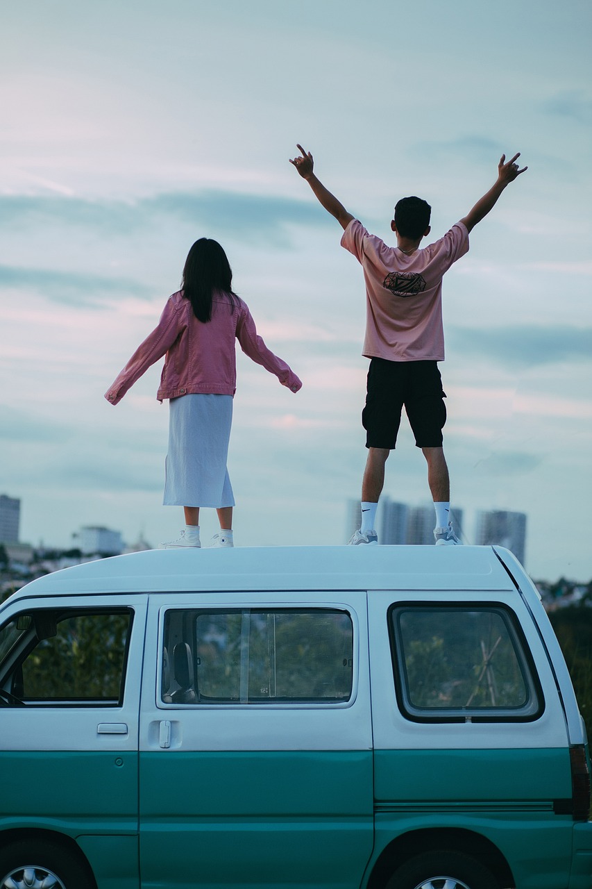 a couple of people standing on top of a van, pexels contest winner, happening, ((pink)), taejune kim, boy and girl, h. u. d