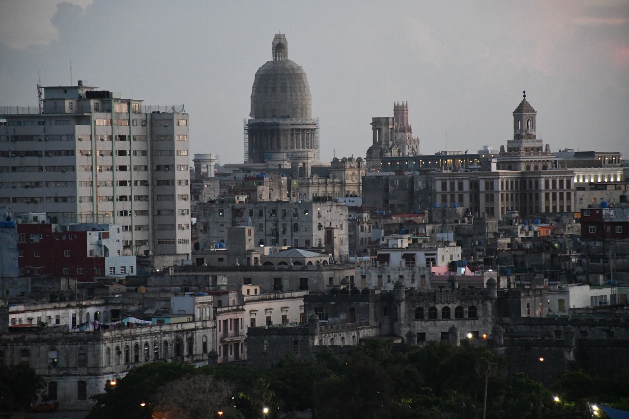 a view of a city from the top of a hill, by Giorgio Cavallon, flickr, cuban revolution, neoclassical tower with dome, early evening, closeup - view