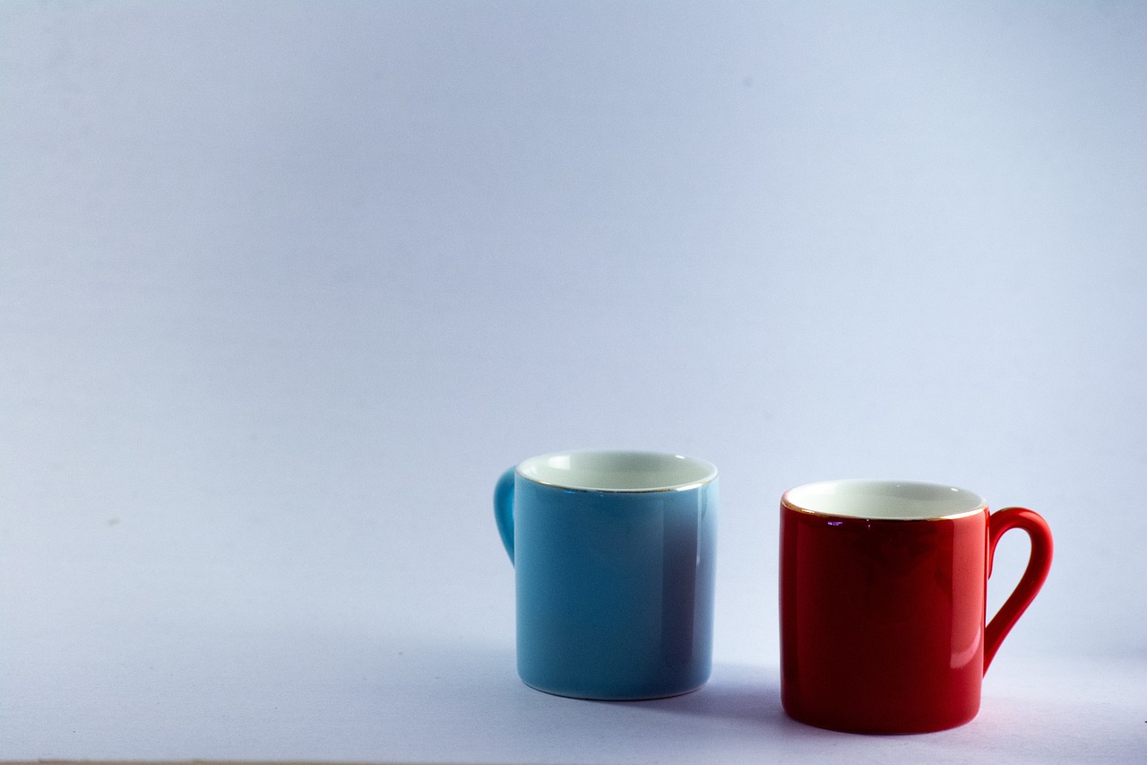 a couple of cups sitting next to each other, minimalism, blue and red two - tone, miniature product photo