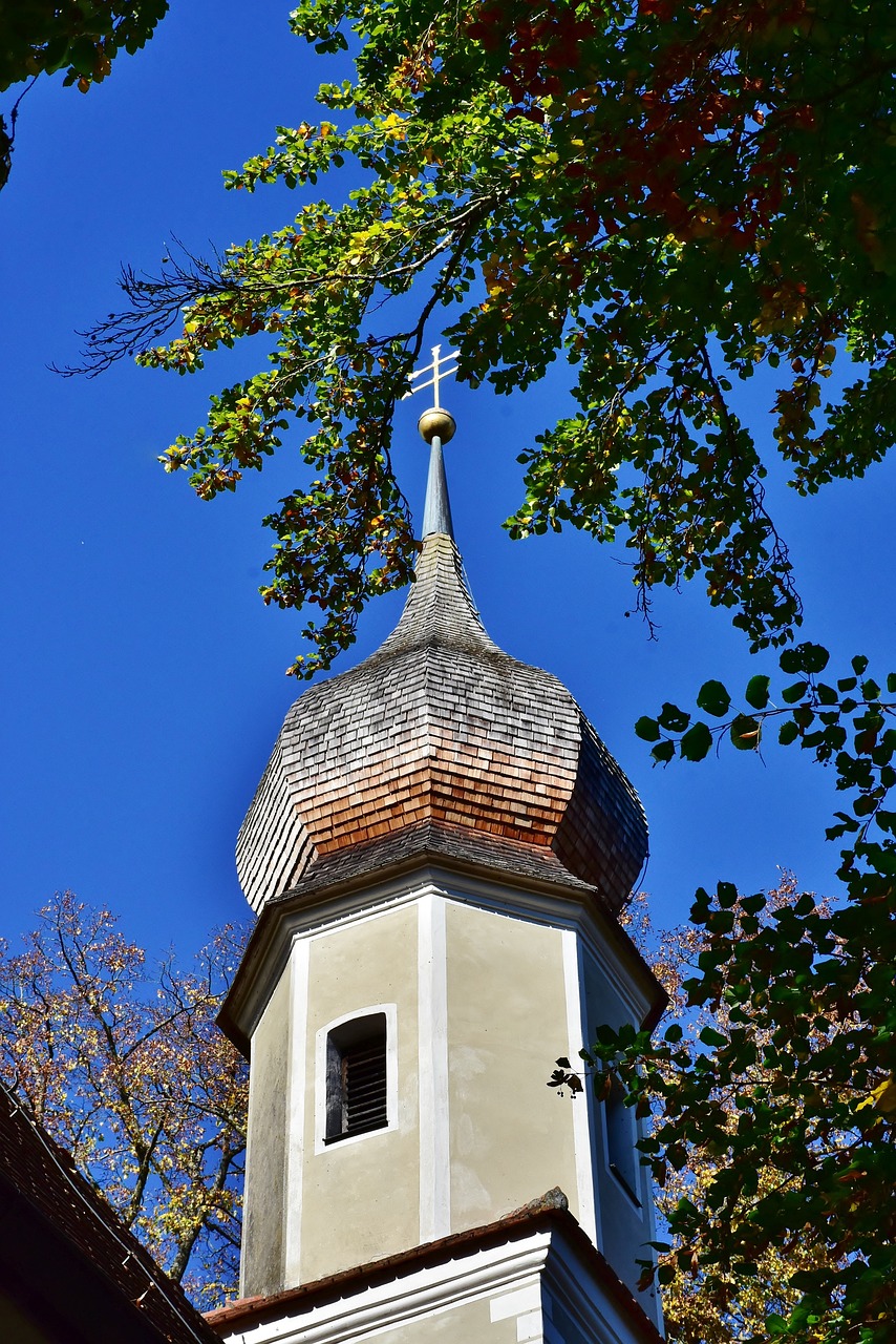 a church steeple with a cross on top of it, by Karl Pümpin, autumn season, spherical, shady, cone shaped