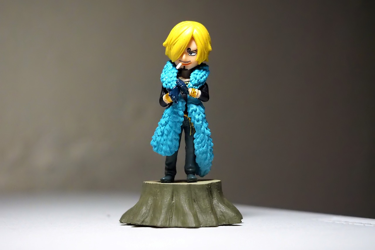 a close up of a figurine on a table, inspired by Li Chevalier, flickr, super saiyan blue, sanji, cute miniature resine figure, ( ( wearing a long coat ) )