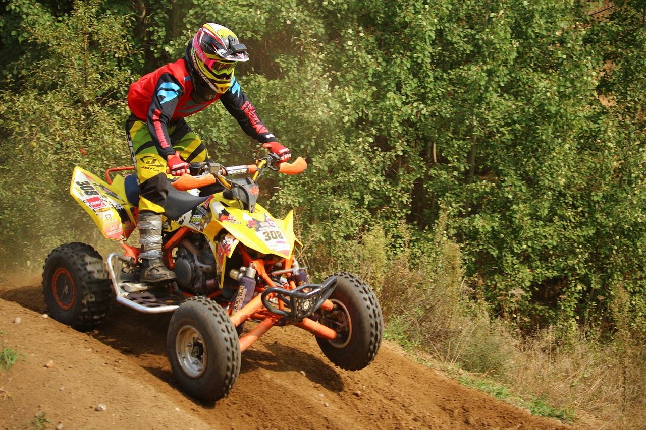 a man riding on the back of a yellow dirt bike, all terrain vehicle race, yellow and orange color scheme, photo taken with provia, ultra 4k