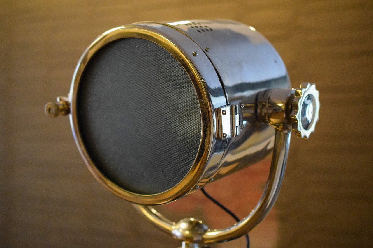a close up of a light with a brick wall in the background, a portrait, by Bob Ringwood, brass equipment and computers, shiny silver with gold trim, 1 9 3 0 s -'4 0 s baltar lenses, the console is tall and imposing