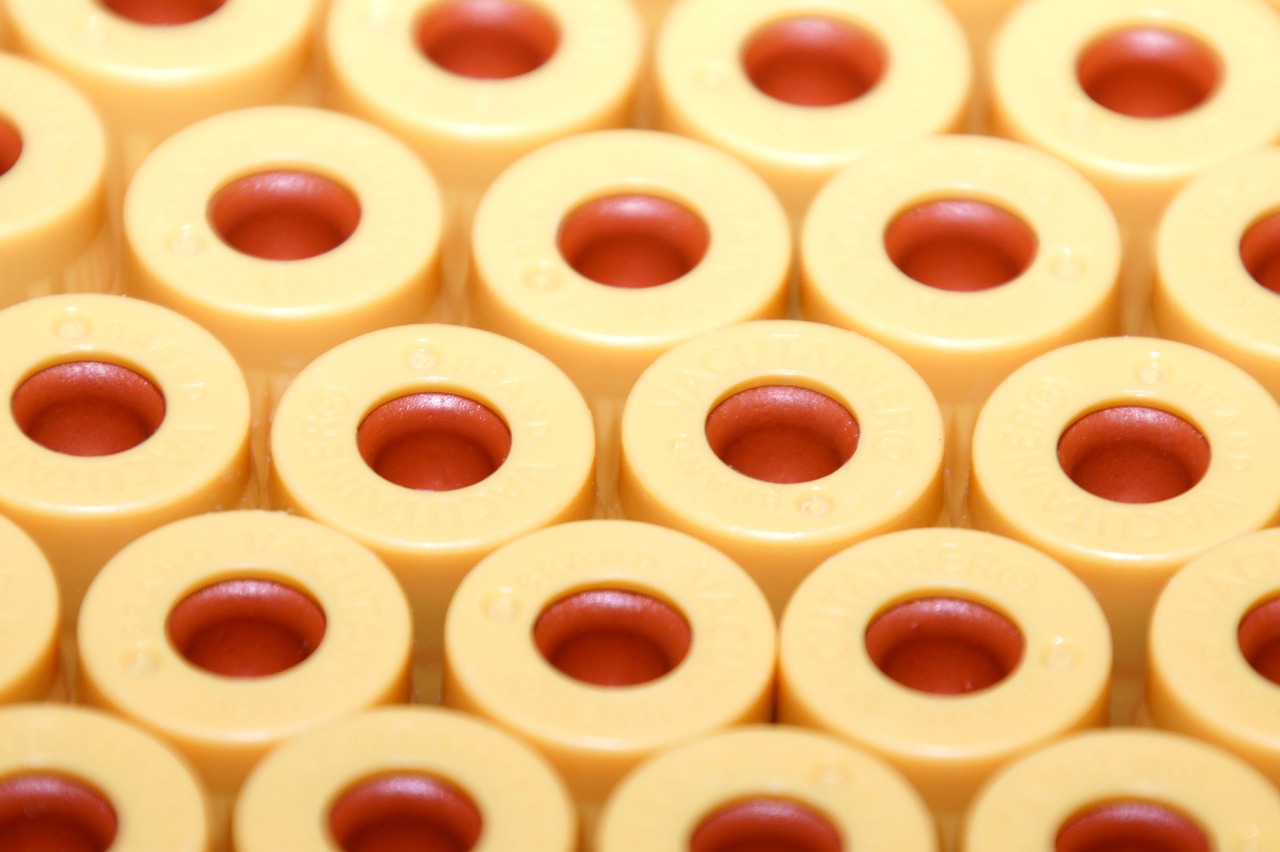 a pile of yellow donuts sitting on top of each other, inspired by Giotto, flickr, bauhaus, blood collection vials, macro 8mm photo, legos, made of swiss cheese wheels