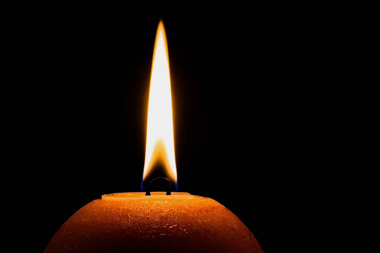 a close up of a lit candle in the dark, by Jan Rustem, pixabay, istockphoto, an orange fire in the background, stock photo, bottom angle